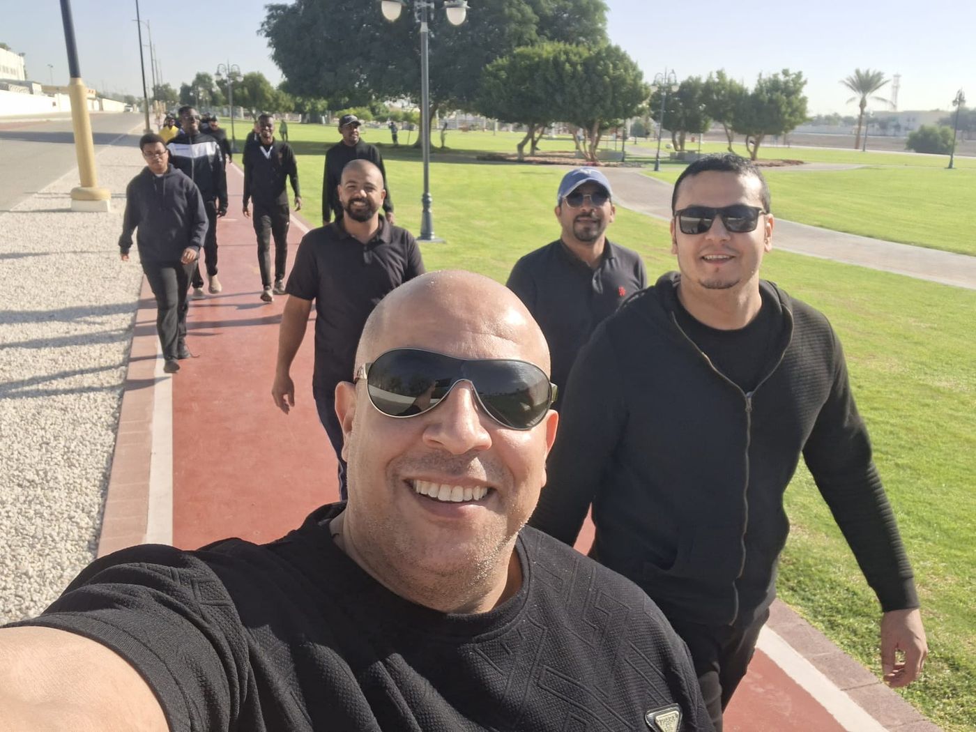 Captain H leading a group walk with community members at an Al Ain park