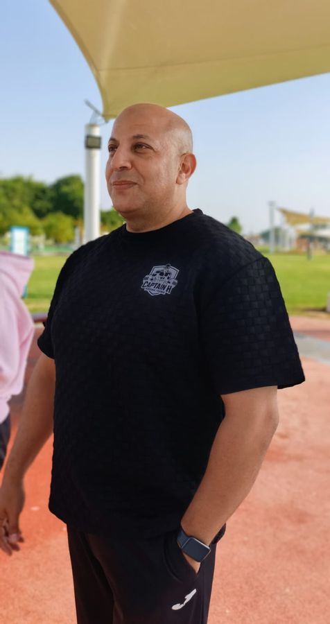 Captain H at an Al Ain park, wearing his Captain H Personal Trainer shirt